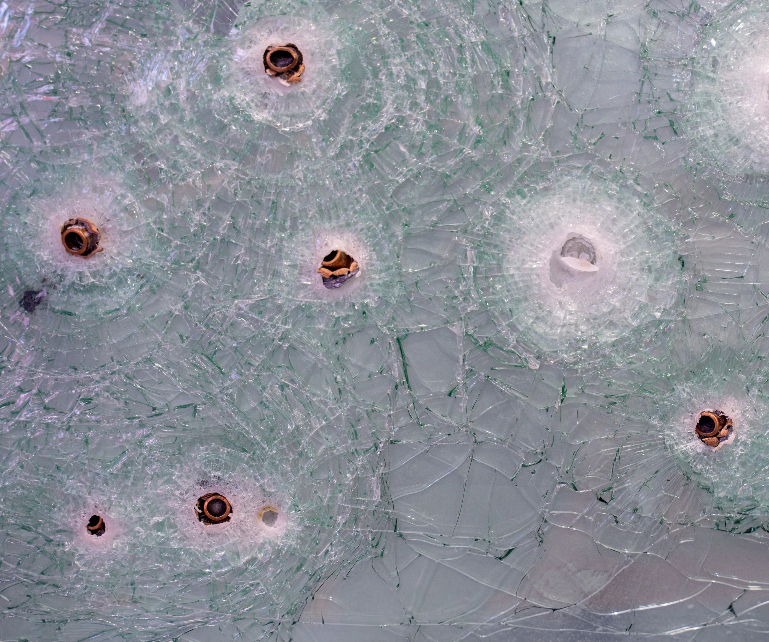 Ballistic impacts in a glass test panel