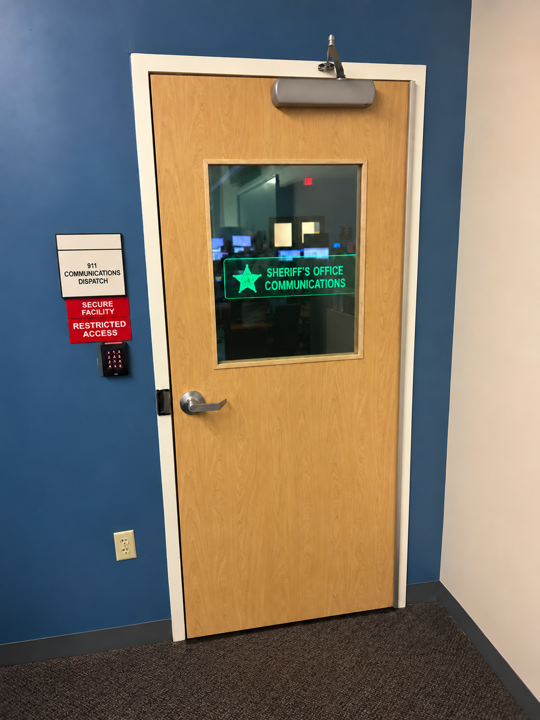 Commercial wood ballistic door installed at a secured communications entrance